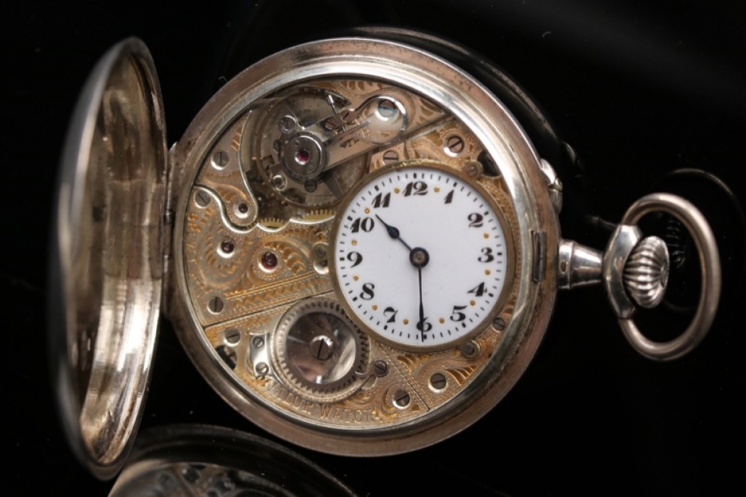 Silver pocket watch with open clockwork