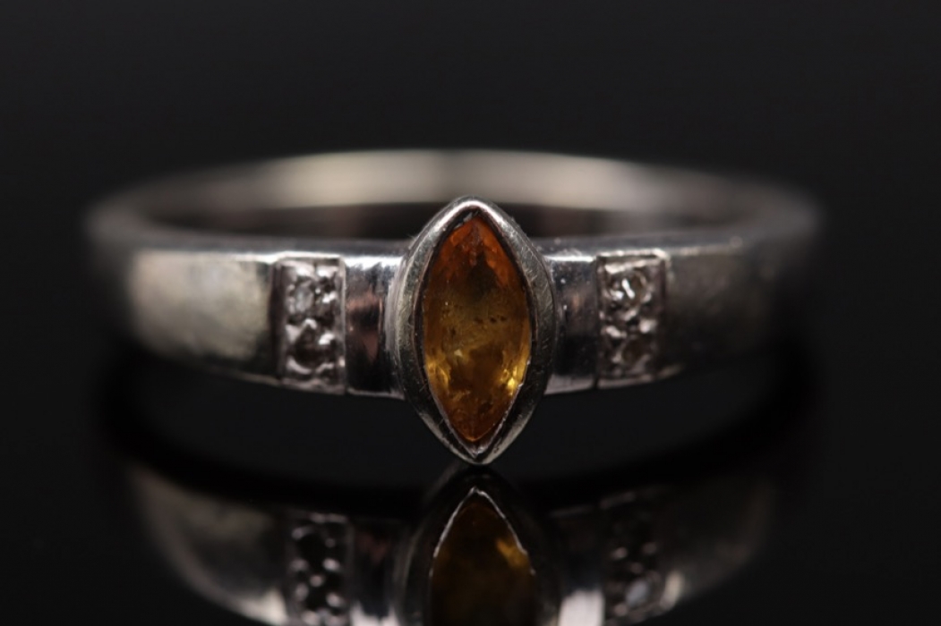 White golden ring with yellow sapphire and diamonds