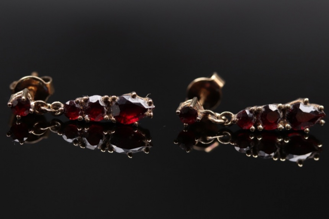 Golden ear studs with red garnets